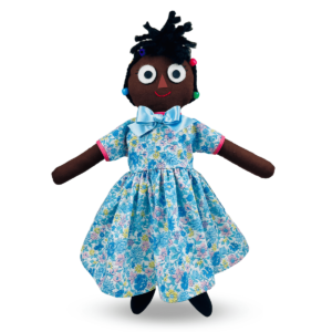 Alt Text: Handmade cloth doll named Annie Okay, featuring braided and beaded yarn hair, intricately embroidered features, vinyl transfers, and artful accents in leather and felt. Stuffed with soft poly-fiber fill for a delightful tactile experience. Easy to care for with a surface wash option. Crafted from premium cotton and cotton-blended fabric, each doll is meticulously made to order, ensuring a personalized touch. Suitable for ages four and up, this artisanal creation seamlessly blends craftsmanship and playfulness. Consider personalizing Annie's skirt with up to twelve letters for an additional fee. A cherished addition to any collection, Annie Okay brings joy and whimsy to playtime!